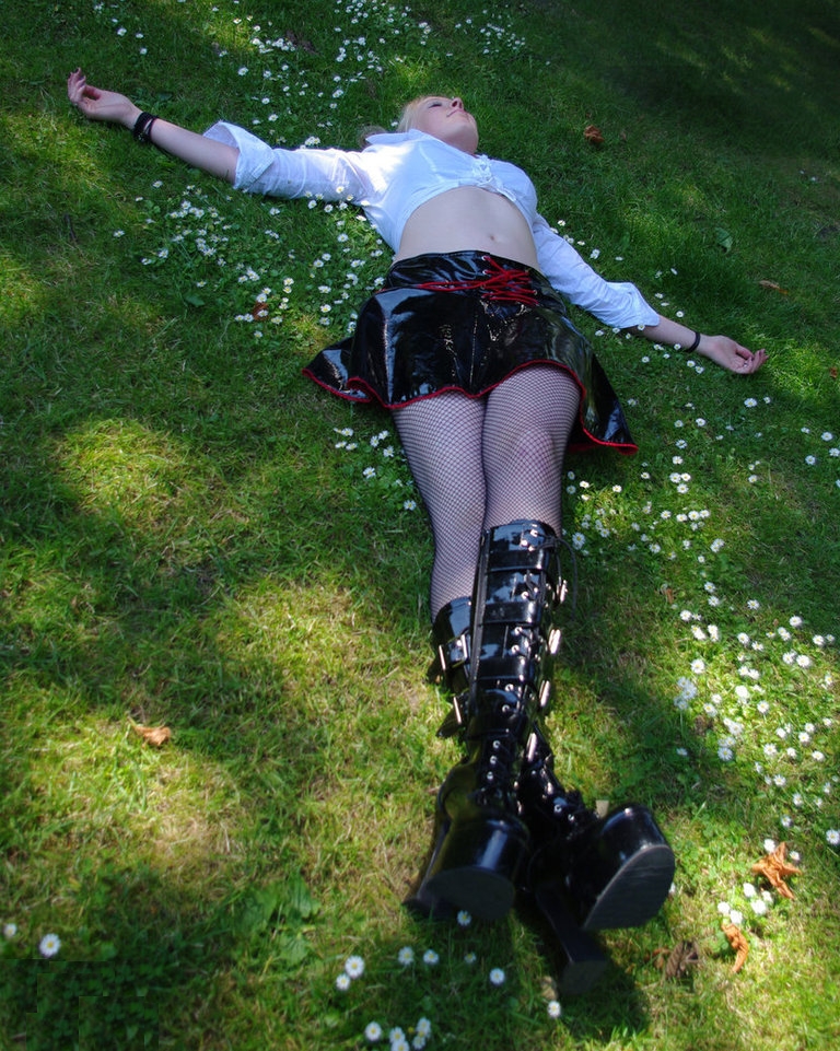 Blonde Gothic Girl wearing Black Fishnet Pantyhose and Black Leather Miniskirt